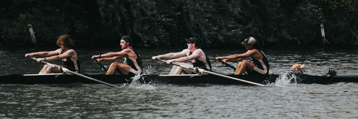 Active men practicing strength movements outdoors
